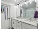 Modern bathroom with double sinks, granite countertops, and a decorative mirror above the vanity at 127 Wickersham Dr, Statesville, NC 28625