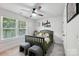 Bright bedroom features a ceiling fan, carpet, and a large window at 127 Wickersham Dr, Statesville, NC 28625