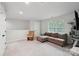 Bonus room features a comfortable couch and a window for natural light at 127 Wickersham Dr, Statesville, NC 28625