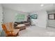 Bonus room features a comfortable couch, cat tree, and window for natural light at 127 Wickersham Dr, Statesville, NC 28625