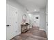Bright entryway featuring wood-look flooring, stylish console table, and white paneled doors at 127 Wickersham Dr, Statesville, NC 28625