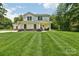 Inviting two-story home with a well-maintained lawn and a charming front porch at 127 Wickersham Dr, Statesville, NC 28625