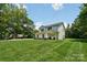 Well-maintained two-story home with a large, green front lawn and basketball court at 127 Wickersham Dr, Statesville, NC 28625