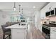 Open kitchen featuring white cabinets, a center island with seating, and stainless steel appliances at 127 Wickersham Dr, Statesville, NC 28625