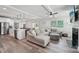 Spacious open-concept living area featuring modern lighting, neutral decor and wood-look flooring at 127 Wickersham Dr, Statesville, NC 28625