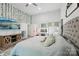 Spacious main bedroom features a TV, natural light, and a vanity with lit mirrors at 127 Wickersham Dr, Statesville, NC 28625
