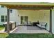 Covered patio with comfortable seating, lighting, grill, and view of the backyard at 127 Wickersham Dr, Statesville, NC 28625