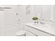 All-white bathroom features a shower-tub combo with shelving and a single-sink vanity at 130 Parker Claire Ln, Kings Mountain, NC 28086