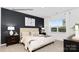 Comfortable bedroom with dark accent wall, plush bedding, and large window providing natural light at 130 Parker Claire Ln, Kings Mountain, NC 28086
