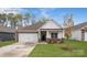 Charming single-story home featuring a two-car garage and landscaped front yard with a stone and white facade at 130 Parker Claire Ln, Kings Mountain, NC 28086