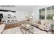 Open-concept living room with large window, sofa, and seamlessly connected to a modern kitchen and dining area at 130 Parker Claire Ln, Kings Mountain, NC 28086
