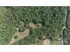 Aerial view showing a property surrounded by a dense green forest with clearings at 1371 Hawks Nest Rd, York, SC 29745