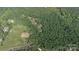 Aerial view showing large property surrounded by lush green forest with a cleared area and buildings at 1371 Hawks Nest Rd, York, SC 29745