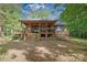 Expansive backyard showcasing a covered porch, wooden deck, and lush greenery for outdoor enjoyment at 1371 Hawks Nest Rd, York, SC 29745