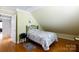 Comfortable bedroom featuring a wrought iron bed, hardwood floors, and a sloped ceiling at 1371 Hawks Nest Rd, York, SC 29745