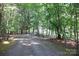 Gravel driveway surrounded by lush greenery and mature trees at 1371 Hawks Nest Rd, York, SC 29745