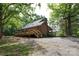 Charming home nestled in a lush, wooded area, featuring a spacious deck and a gravel driveway at 1371 Hawks Nest Rd, York, SC 29745