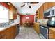 Galley kitchen featuring warm wood cabinets and stainless steel appliances, connected to an eat-in dining area at 1371 Hawks Nest Rd, York, SC 29745