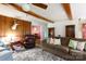 Cozy living room featuring hardwood floors, comfortable seating, and wood paneled wall at 1371 Hawks Nest Rd, York, SC 29745