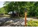 Functional outbuilding in a wooded area, featuring a metal roof, gravel lot and covered bay at 1371 Hawks Nest Rd, York, SC 29745