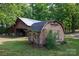 Exterior shot of an outbuilding, featuring wood siding, plants and greenery at 1371 Hawks Nest Rd, York, SC 29745