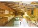 View of workshop featuring pegboard walls, cabinets, exposed rafters and table saw with assembly table at 1371 Hawks Nest Rd, York, SC 29745