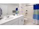 Modern bathroom featuring double sinks, white cabinetry, a shower-tub combo with a blue and white curtain at 138 Rustling Waters Dr, Mooresville, NC 28117