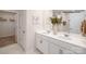 Bright bathroom featuring double sinks with white cabinets, large mirrors, and modern fixtures at 138 Rustling Waters Dr, Mooresville, NC 28117