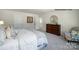Relaxing bedroom with a plush bed, soft carpet, dresser and an open door to the bathroom at 138 Rustling Waters Dr, Mooresville, NC 28117