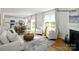 Open-concept living space with a fireplace, dining area, and cozy seating, perfect for gatherings at 138 Rustling Waters Dr, Mooresville, NC 28117