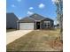 Charming single-story home with a two-car garage and stone accents at 150 Parker Claire Ln, Kings Mountain, NC 28086