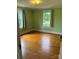Cozy bedroom with hardwood floors and natural light from two windows at 1510 Stoker Ter, Albemarle, NC 28001