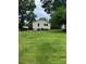 Charming yellow home surrounded by lush greenery and a well-manicured lawn at 1510 Stoker Ter, Albemarle, NC 28001