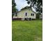 Quaint yellow home with white trim, inviting front entrance, and a well-maintained lawn at 1510 Stoker Ter, Albemarle, NC 28001