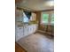 Functional kitchen features white cabinetry and tile floors at 1510 Stoker Ter, Albemarle, NC 28001
