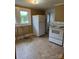 Kitchen with appliances and tile floors with windows allowing natural light at 1510 Stoker Ter, Albemarle, NC 28001