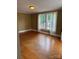 Bright living room featuring hardwood floors and multiple windows at 1510 Stoker Ter, Albemarle, NC 28001
