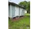 Exterior of a small, weathered outbuilding with peeling blue paint and white doors at 1510 Stoker Ter, Albemarle, NC 28001