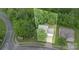 Aerial view of a home surrounded by mature trees, showing the layout of the property and its proximity to greenery at 152 Hampshire Dr, Mooresville, NC 28115