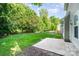 Backyard featuring a concrete patio and grassy lawn, with a wooden fence bordering the property line at 152 Hampshire Dr, Mooresville, NC 28115