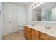 Bright bathroom with double sinks, wood cabinets, and a large vanity mirror at 152 Hampshire Dr, Mooresville, NC 28115