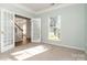 Neutral bedroom with french doors, carpet flooring, and view of the home's entry at 152 Hampshire Dr, Mooresville, NC 28115