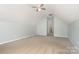 Large bonus room under the roof with ceiling fan, offering flexible space for various lifestyle needs and comfort at 152 Hampshire Dr, Mooresville, NC 28115