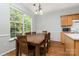 Eat-in kitchen area with modern appliances, wooden cabinetry, and lots of natural light at 152 Hampshire Dr, Mooresville, NC 28115