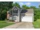 Two-story home featuring neutral siding, brick accents, and an attached two-car garage at 152 Hampshire Dr, Mooresville, NC 28115