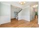 Welcoming foyer featuring hardwood floors, a staircase, and elegant wainscoting detail at 152 Hampshire Dr, Mooresville, NC 28115