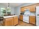 Eat-in kitchen area with modern appliances, wooden cabinetry, and lots of natural light at 152 Hampshire Dr, Mooresville, NC 28115