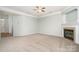 Bright and spacious living room featuring a fireplace, neutral carpeting, and crown molding at 152 Hampshire Dr, Mooresville, NC 28115