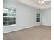 Spacious main bedroom with plush carpeting, a tray ceiling, and great natural light at 152 Hampshire Dr, Mooresville, NC 28115