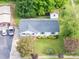 Aerial view of white house with manicured lawn, mature landscaping, and driveway at 1613 Hamilton St, Charlotte, NC 28206